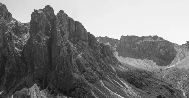 Stunning black and white photo capturing the rugged peaks of the Dolomites in Veneto, Italy.