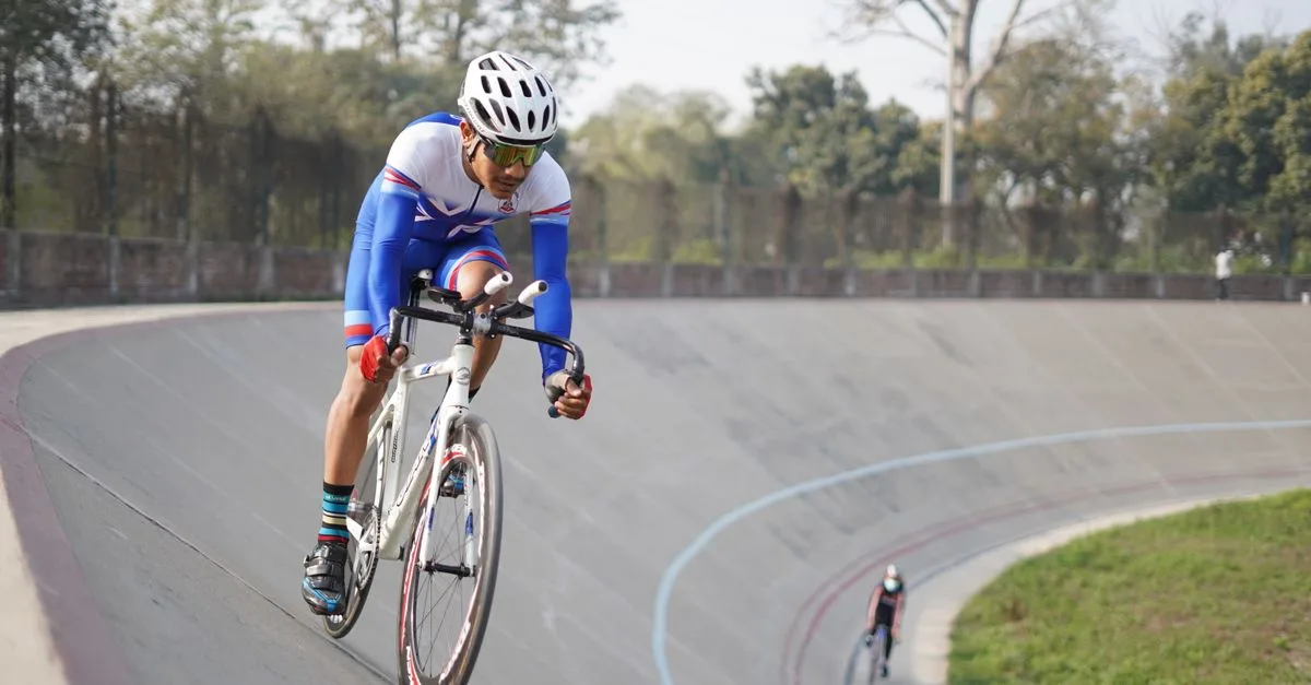 Cyclist in professional gear competing in a velodrome race in Lahore, Pakistan.