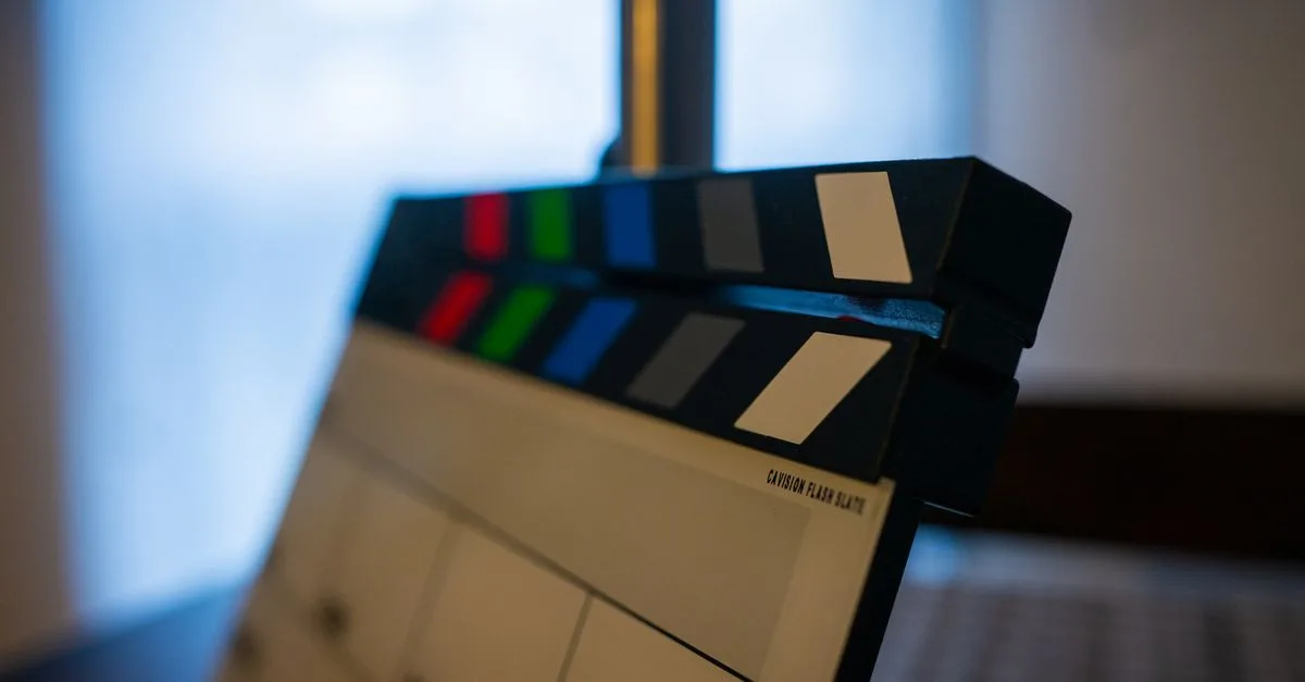 Detailed view of a film clapperboard indoors, highlighting film industry tools.