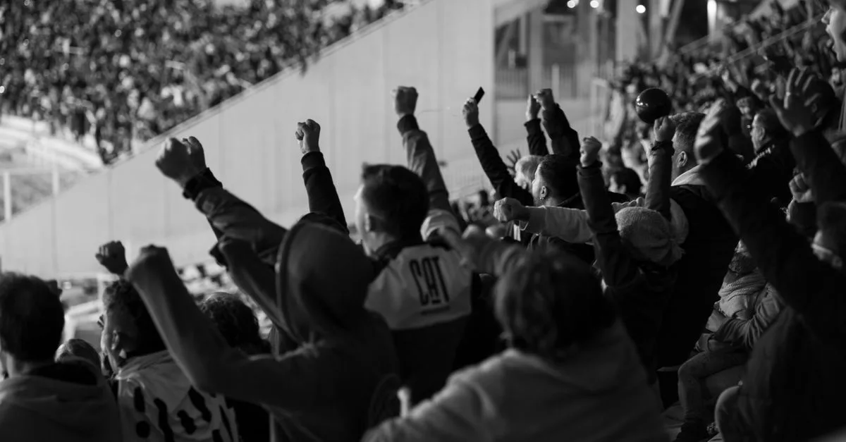 Vibrant crowd of football fans cheering in a Córdoba stadium, Argentina.