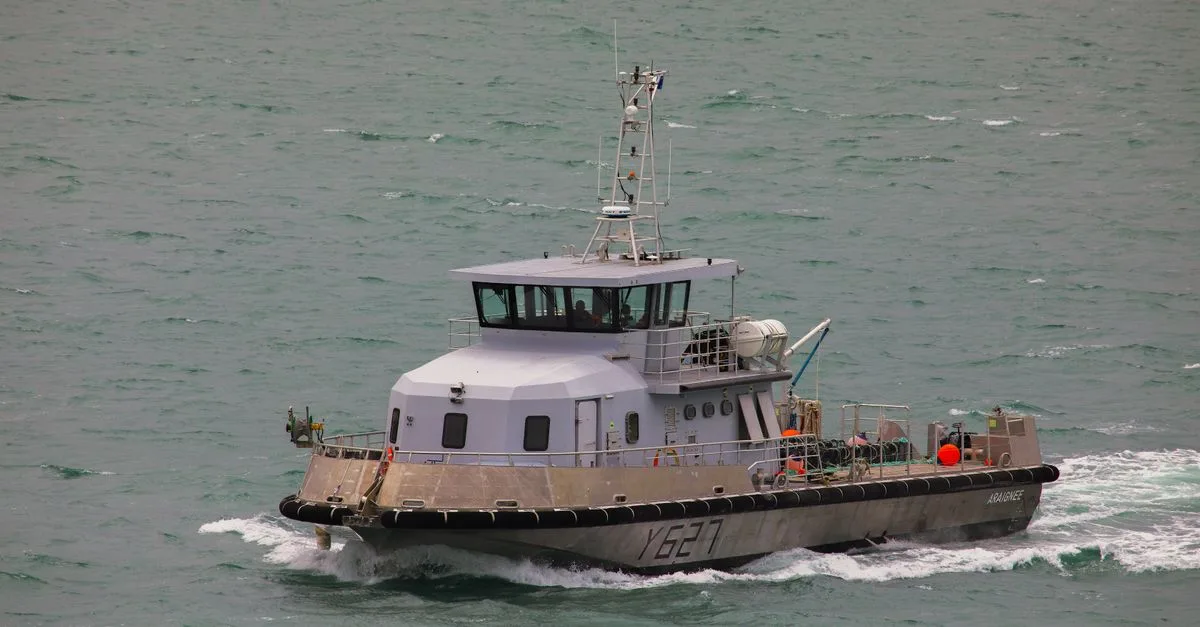 A patrol boat cruises through the choppy waters of Normandy, France, showcasing maritime security.