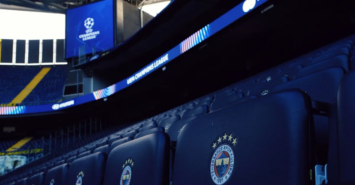 Rows of empty seats in a stadium with UEFA Champions League branding.