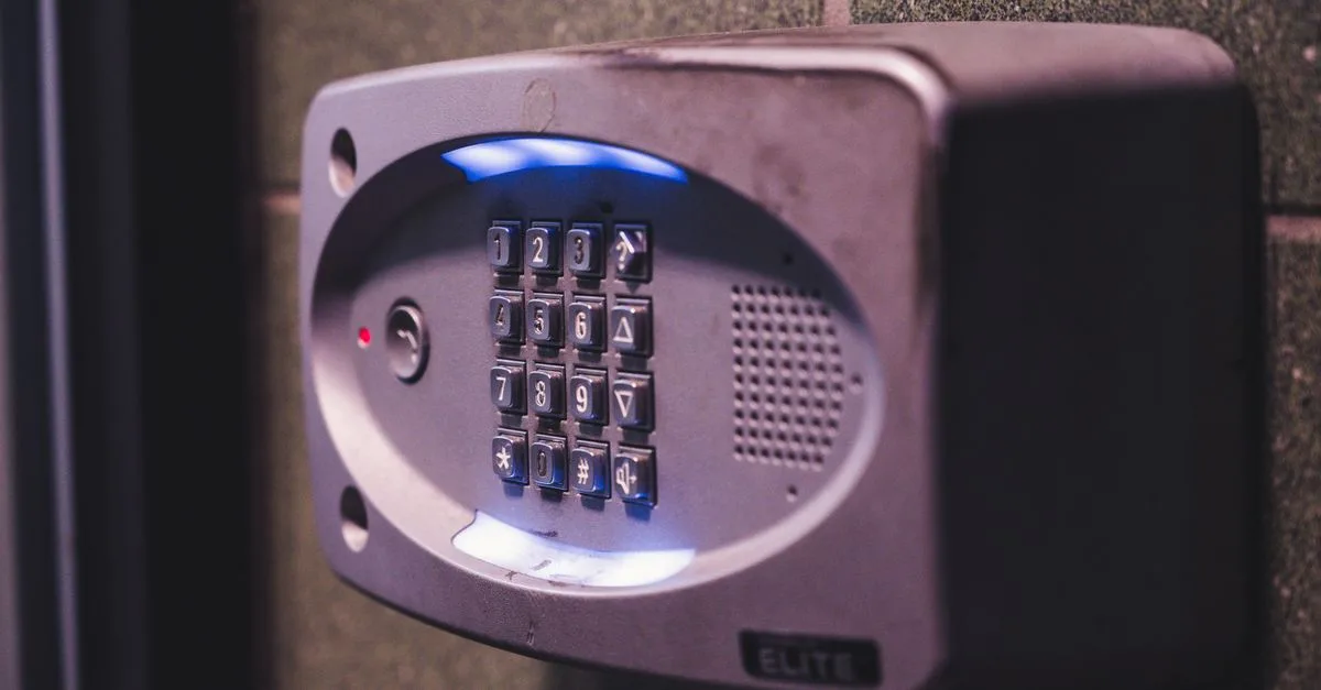A close-up image of an illuminated security keypad mounted on a wall.