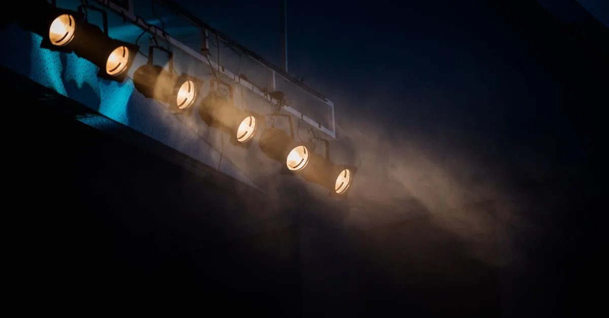 Moody stage lighting with smoke effect to add atmospheric drama.