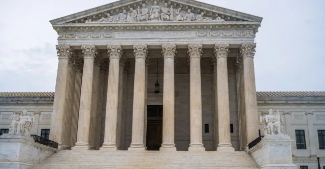 Front view of the iconic US Supreme Court building showcasing its grand columns and classic architecture.