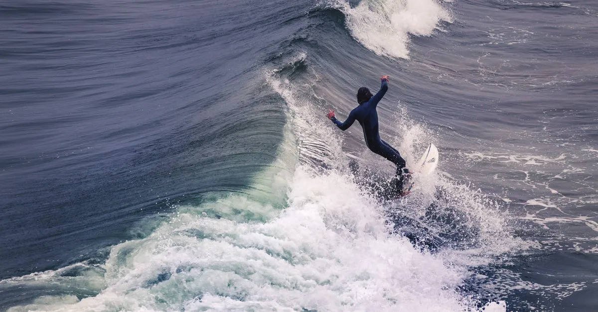 Dynamic shot of a surfer expertly riding waves at Pismo Beach, showcasing skill and thrill.