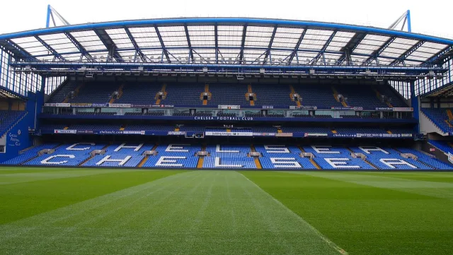 A professional football stadium pitch under stadium lights.