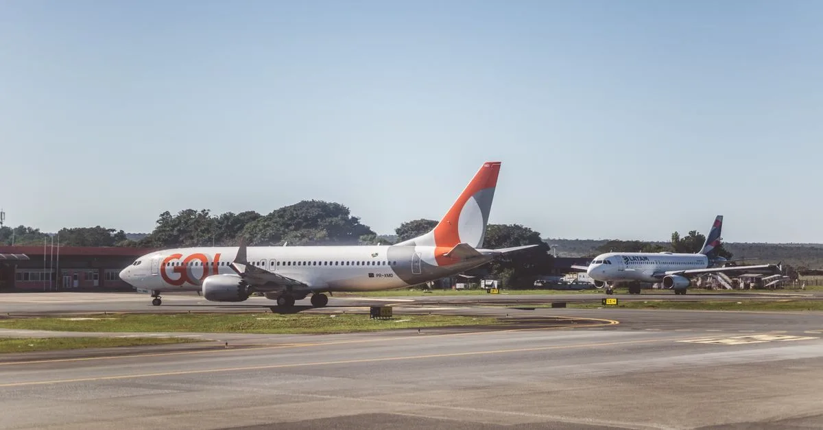Airliners taxiing on a sunny day at an airport, ready for takeoff.