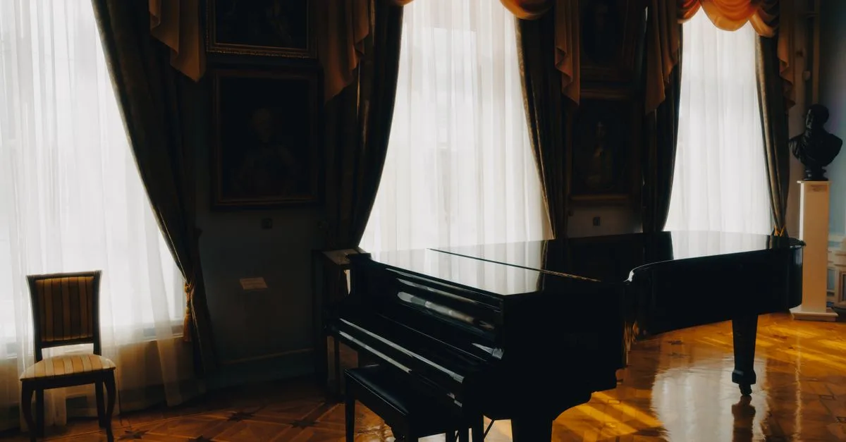 A grand piano in a sunlit room with elegant drapes and classic decor, enhancing a luxurious atmosphere.