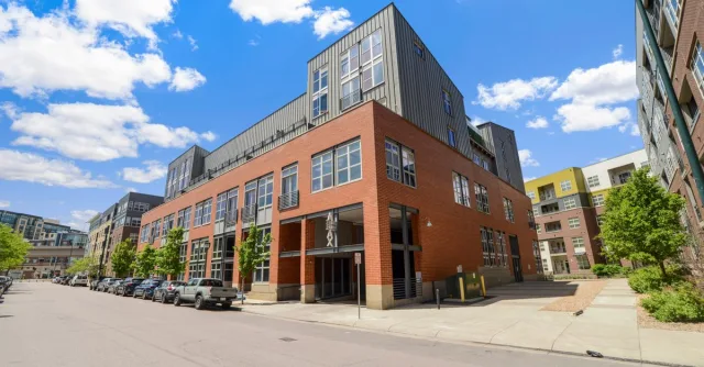 Contemporary urban building exterior with clear blue sky in Denver.