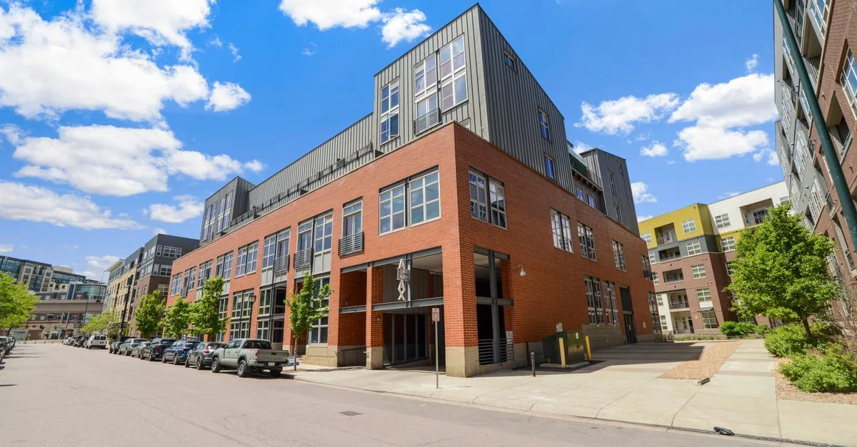 Contemporary urban building exterior with clear blue sky in Denver.