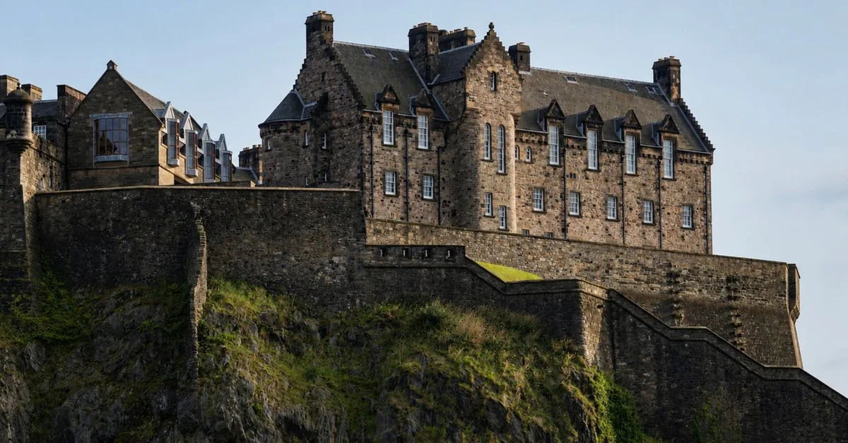 Dramatic view of Edinburgh Castle, a historic fortress in Scotland, atop Castle Rock.