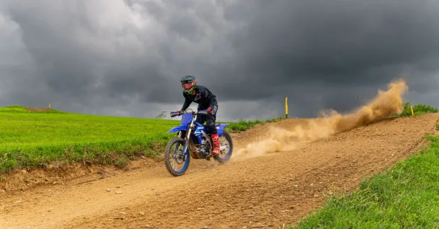 Exciting dirt bike racing on a stormy day in Pennsylvania's countryside.