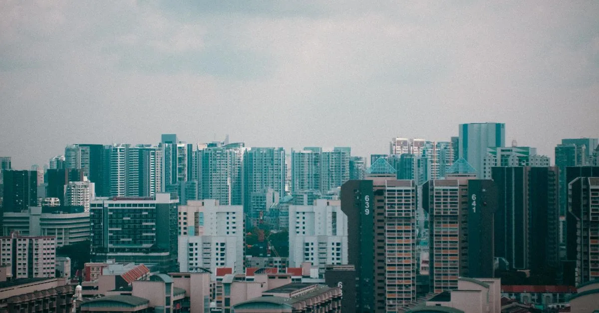 A stunning cityscape view of Singapore's high-rise buildings under a cloudy sky, showcasing urban architecture.