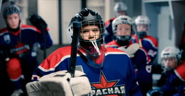 Young ice hockey players geared up in dressing room, ready for game. Team spirit and readiness.