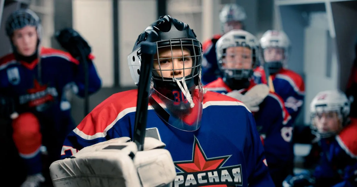 Young ice hockey players geared up in dressing room, ready for game. Team spirit and readiness.