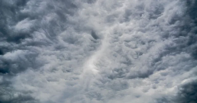 A stunning view of dramatic cumulus clouds filling the sky, showcasing dynamic weather patterns.