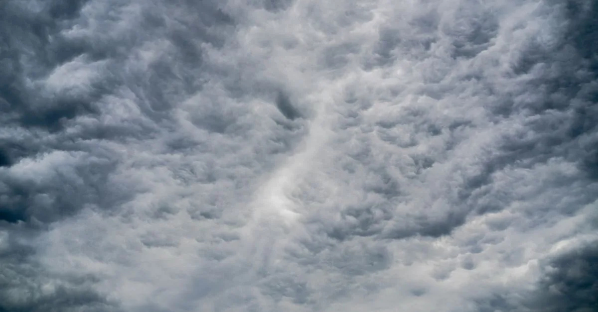 A stunning view of dramatic cumulus clouds filling the sky, showcasing dynamic weather patterns.