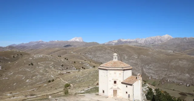 Scenic view of Santa Maria della Pietà church amidst Italy's Abruzzo hills and mountains.