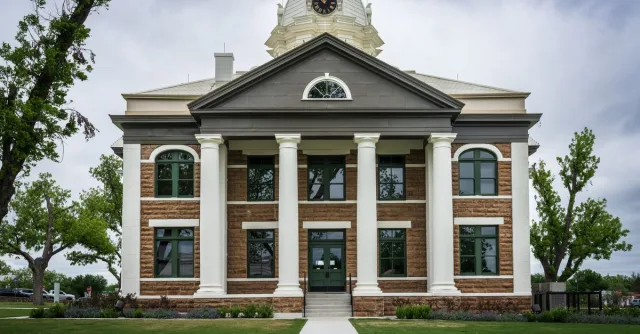 Classic architectural design of Mason County Courthouse, Texas amid lush greenery.