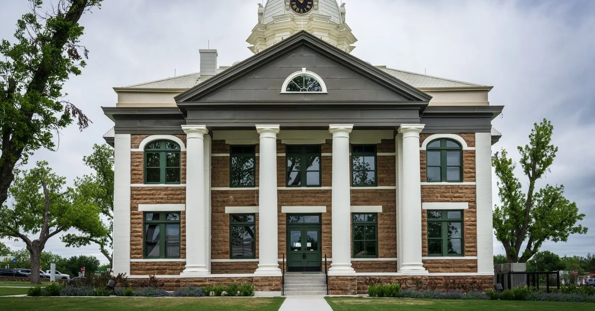 Classic architectural design of Mason County Courthouse, Texas amid lush greenery.
