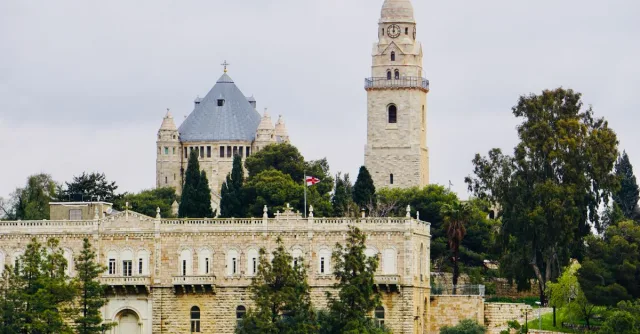 View of Jerusalem's Mount Zion with historic architecture and lush greenery.