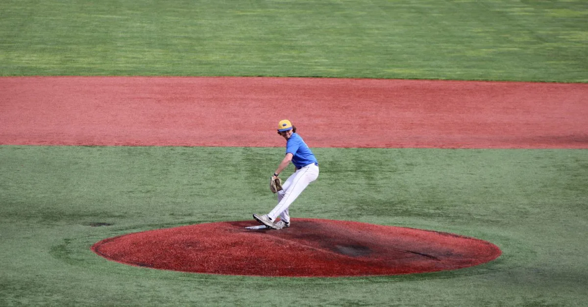 Teenage baseball pitcher throws a ball on an outdoor field, showcasing athletic skill.