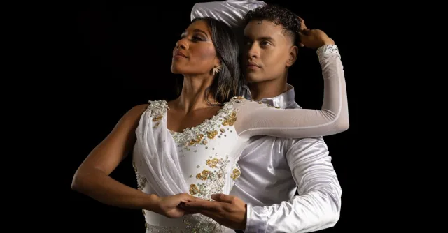 Captivating image of a dance couple in graceful poses against a black backdrop.
