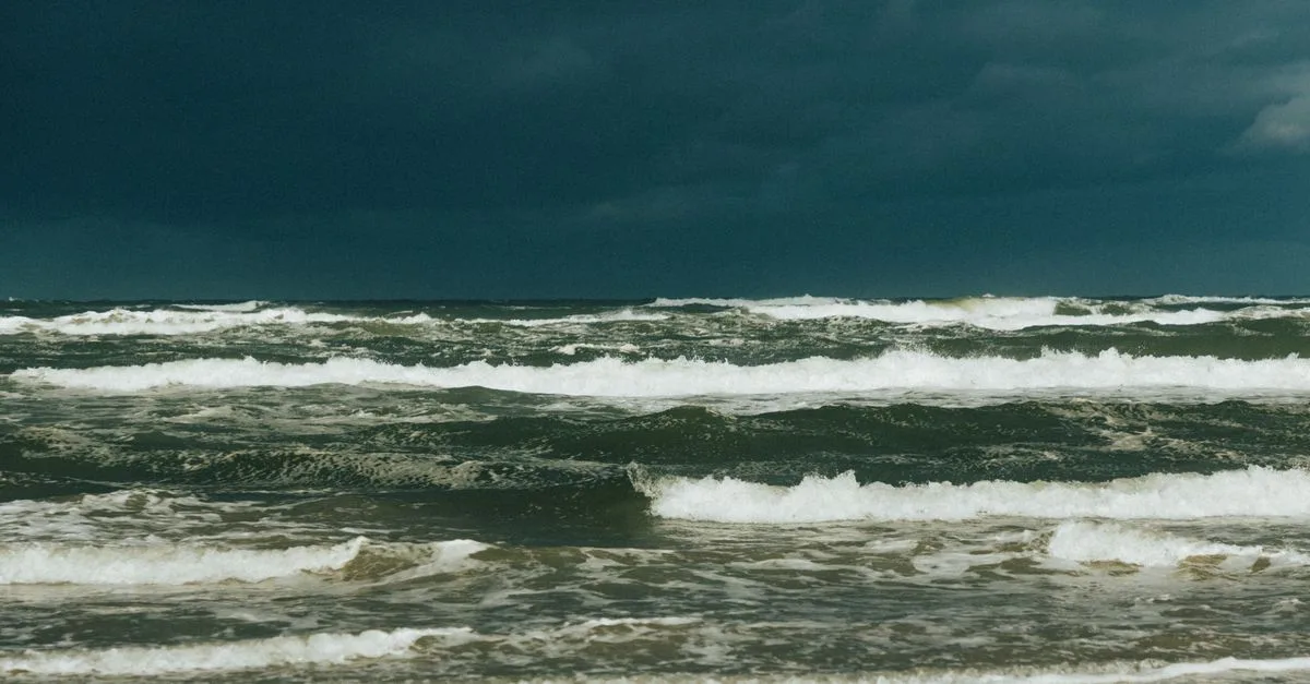 Captivating view of a stormy sea under dark clouds, showcasing powerful ocean waves.
