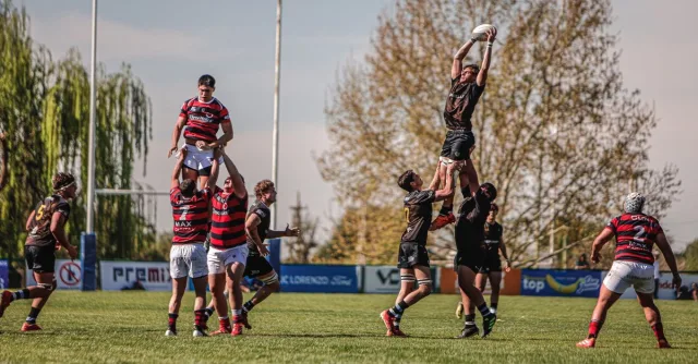 Intense lineout action during a competitive rugby match on a sunny day.