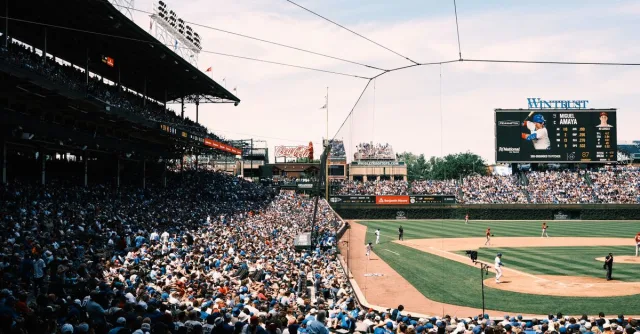 Panoramic view of a bustling baseball game at Wrigley Field, Chicago, capturing the vibrant atmosphere.
