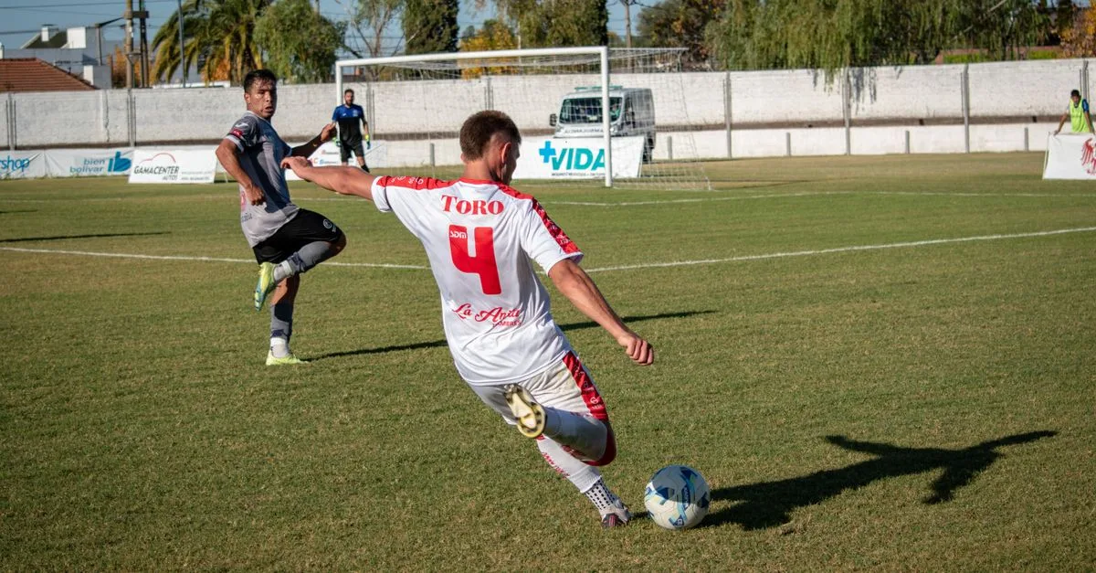 Dynamic shot of players engaged in a competitive soccer match outdoors.