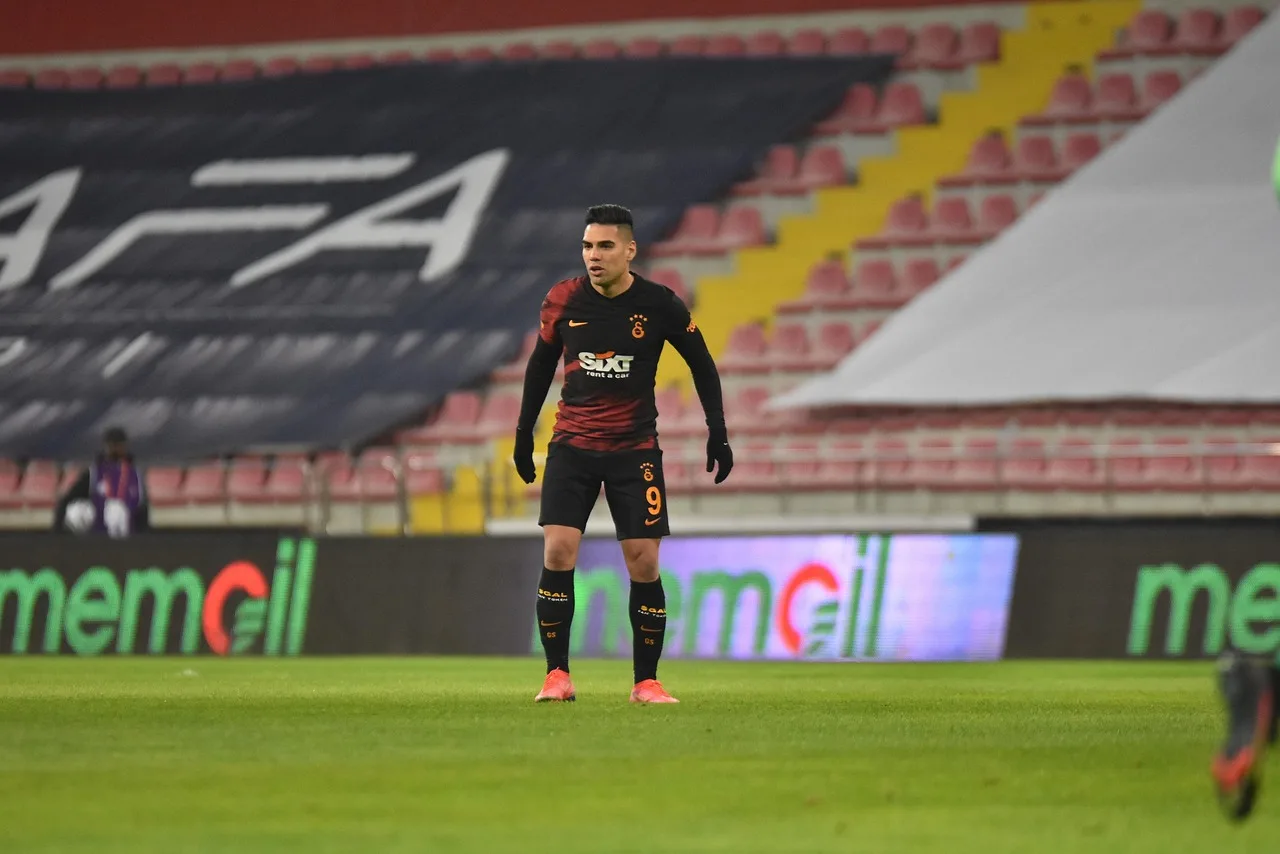 A wide shot of a professional football stadium during a match.