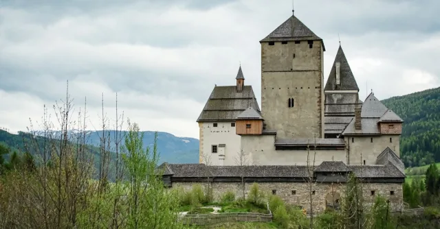 Majestic view of Mauterndorf Castle surrounded by lush greenery in Salzburg, Austria.