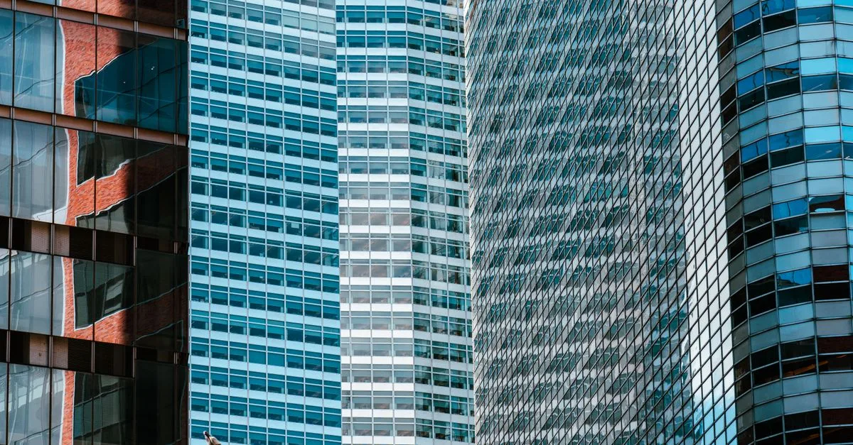 Close-up view of contemporary skyscrapers with reflections on glass facades in urban financial district.