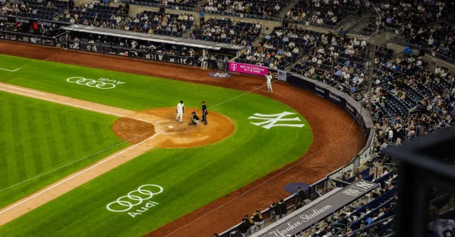Aerial view of a baseball game at Yankee Stadium with a packed crowd.