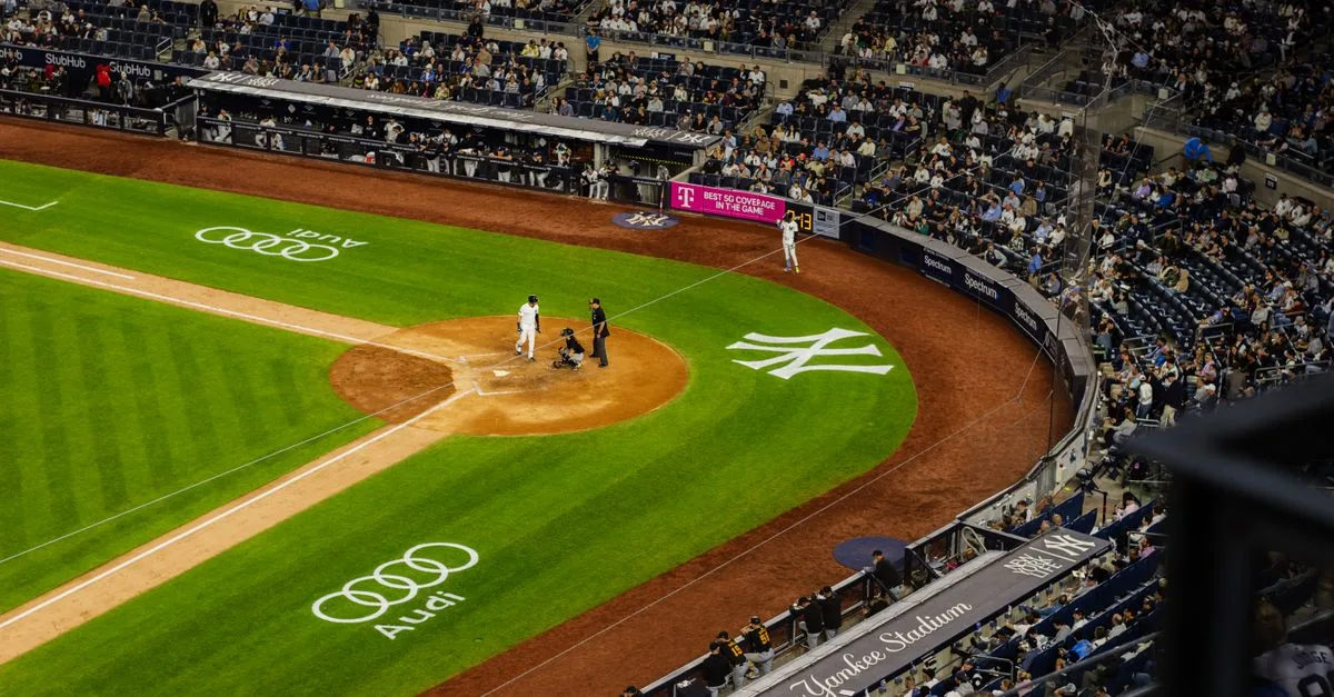Aerial view of a baseball game at Yankee Stadium with a packed crowd.