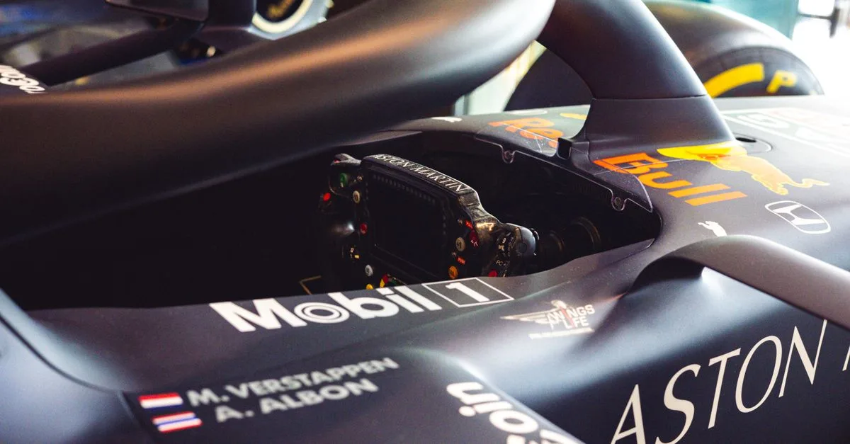 Detailed close-up of a Formula One race car cockpit highlighting sponsors and branding.