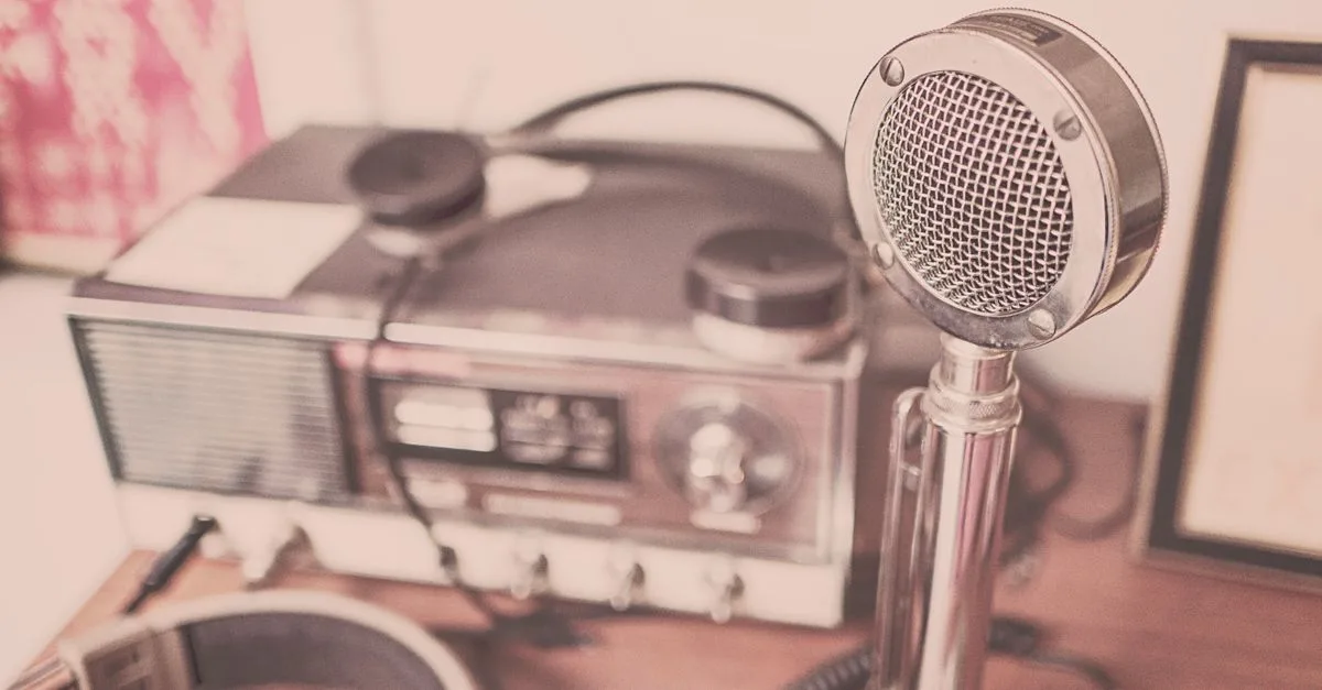 A classic vintage microphone and radio set with headphones displayed on a wooden table.