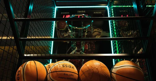 Close-up view of basketballs lined up for an arcade basketball hoop game.