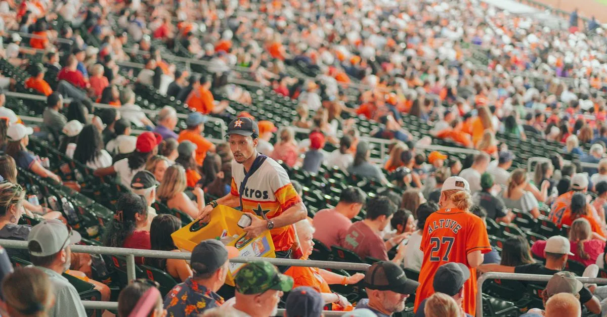 Packed Houston stadium featuring enthusiastic baseball fans during a major league game.