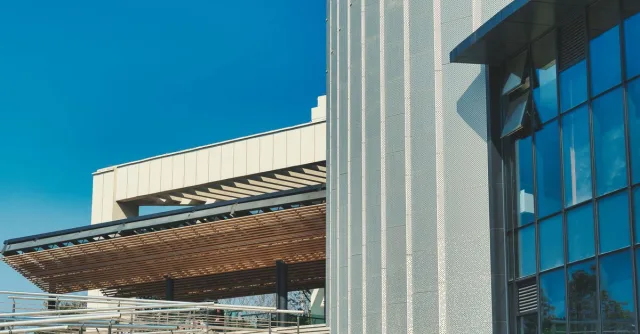 Contemporary building showcasing modern architecture with glass facade and structural design.
