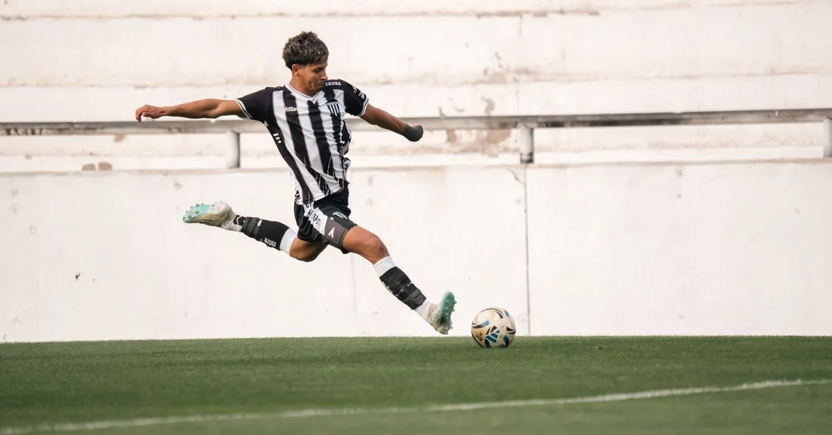 Dynamic shot of a soccer player in mid-air kick on green field.
