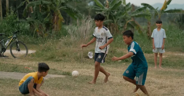 Young boys engaging in a friendly soccer match on a grassy field.