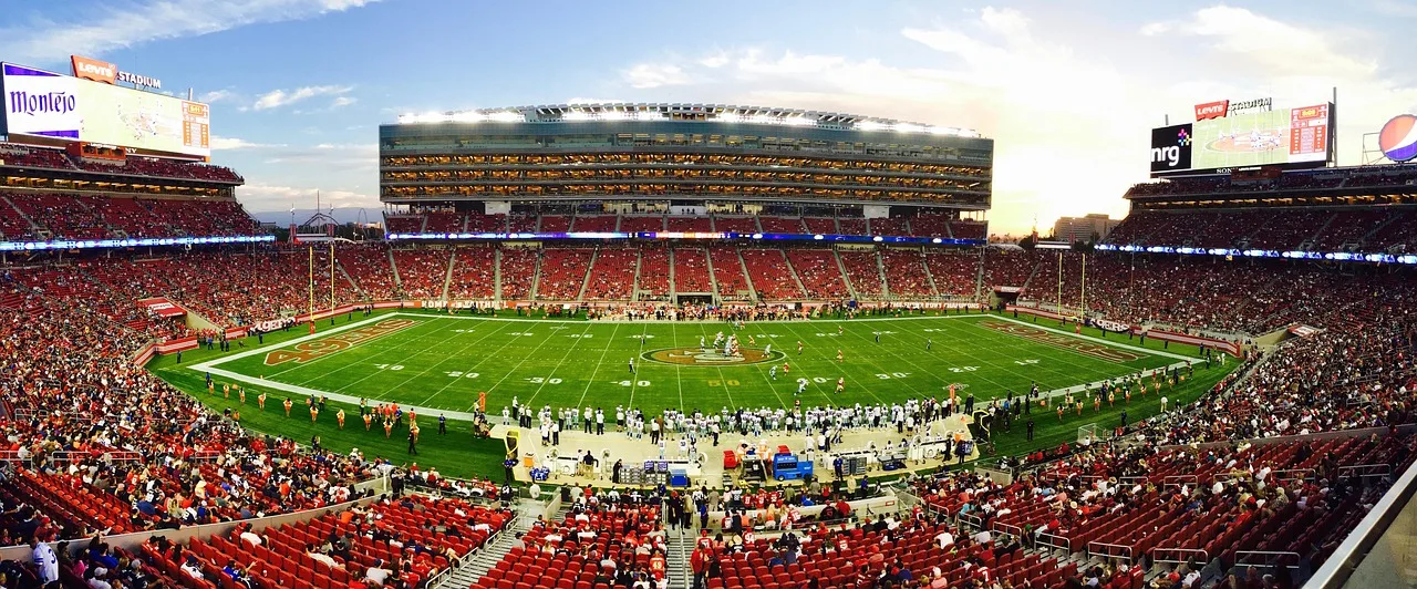 A wide shot of a crowded football stadium during a match.