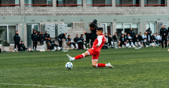 Exciting moment during a soccer match with players in action on a grassy field.