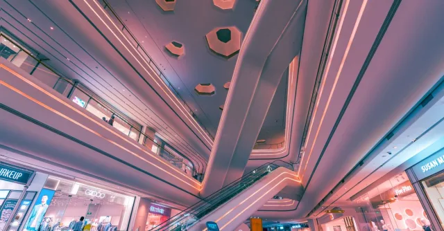 Explore the futuristic design and vibrant lighting of a Shenzhen shopping mall interior.