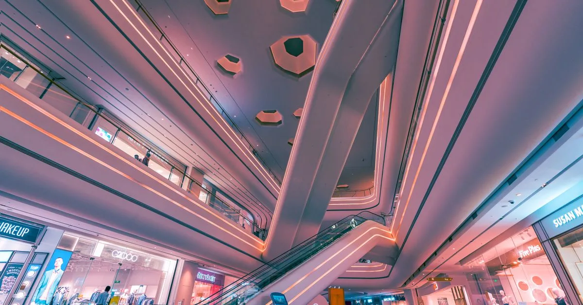 Explore the futuristic design and vibrant lighting of a Shenzhen shopping mall interior.