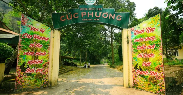 Entrance gate to Cuc Phuong National Park, surrounded by lush greenery in Ninh Bình, Vietnam.