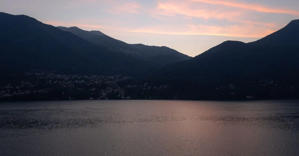 Beautiful sunset view over Lake Como with mountains in Lombardy, Italy.
